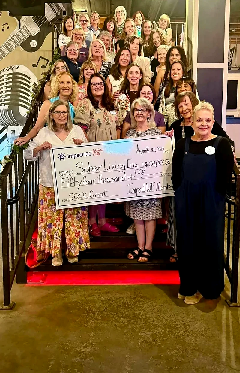 Community supporters gathered with a grant presentation check for Sober Living, Inc. at an Impact100 Wichita Falls event